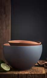 a few bowls of food on a wooden table