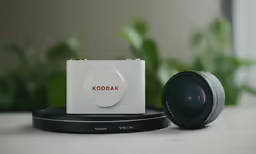 a small camera and lens on the ground