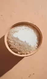 a brown bowl filled with a lot of white liquid