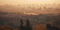 two people standing on a hill with skyline and buildings behind them