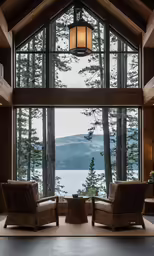 this is a living room with chairs and table near a huge window