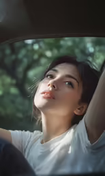 the girl is driving in the car