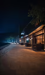 the building is along the waterfront and lights shine on it