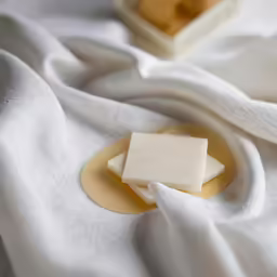 a block of wax that is on top of some white cloth