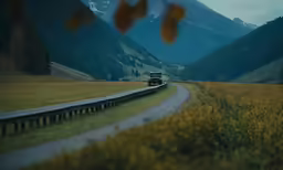 an open road that stretches toward the camera from a distant location in the country