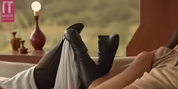 woman wearing black boots laying on top of white sheets