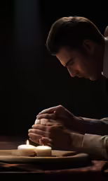 a man is holding out his hand with some candles