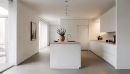 the kitchen has an island in it, but no stools