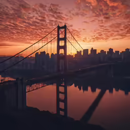 a sunset view of the bay bridge and the city