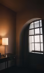 a dark room with a window and small table next to it
