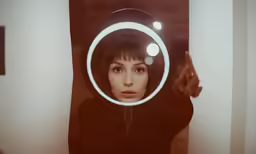 a woman looking through a magnifying glass with light