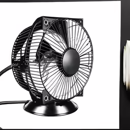 a fan sitting on top of a desk