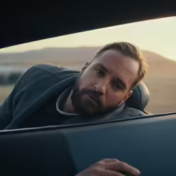 the man is sitting in his car driving