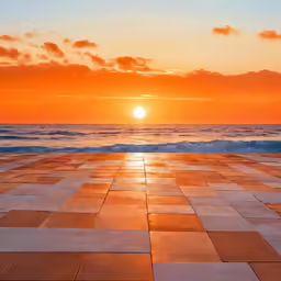 sunset over an empty beach with tiles arranged in the center