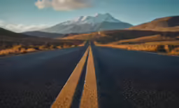 this is a highway with mountains in the background