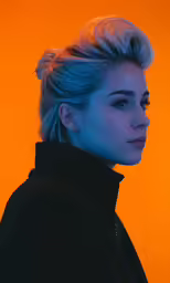 a woman with blonde hair in a black jacket