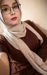 the girl has glasses and a scarf on her head