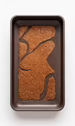 a pan of chocolate cake with a design on top