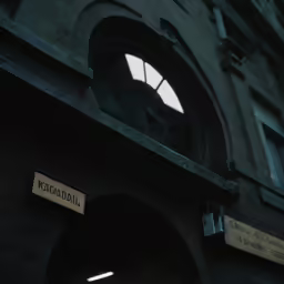 a street sign near a brick building with arched window