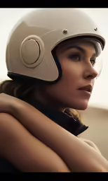 a woman wearing a helmet while she is holding her arm around her