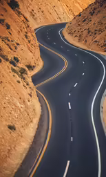 two separate road winding through mountains on each side
