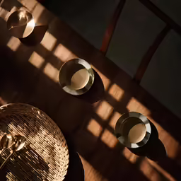a view of the back of a wooden table with plates and bowls