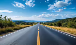 a highway with two lanes and trees around it