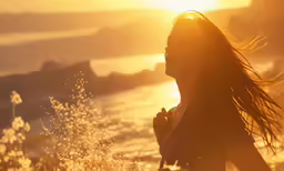 a young woman in the sunlight near the sea
