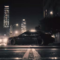 the car is driving down the street in the city at night