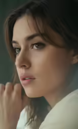 a woman with her hand on her face