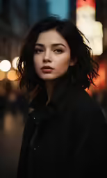 a woman in black shirt standing in street next to buildings