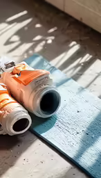 two rolls of camera film laying on top of a mat