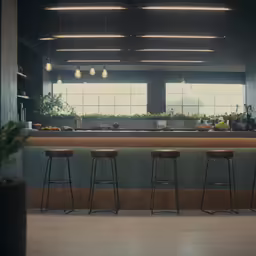 a long kitchen area with stools and counter top