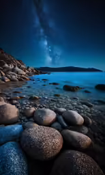 the milky in the sky over a rocky beach