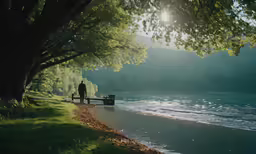 two people sitting on a bench next to the water