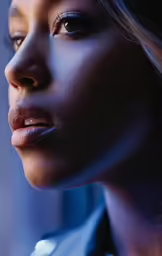 a black woman is looking down and to her left