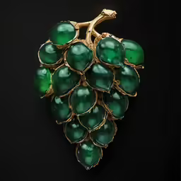 an unusual green brooch is sitting on a dark surface