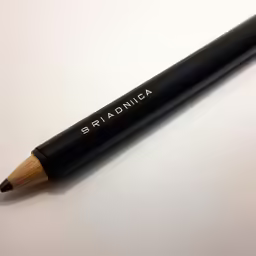 an angled pen laying on top of a table