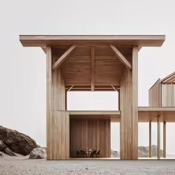 a small wooden house with two towers and table