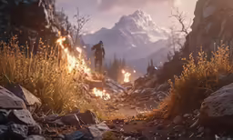 a person walking down a rocky trail towards mountains