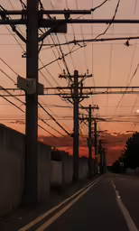 the sky is red and the street light is on