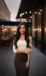 a woman posing in a dress with her arms crossed