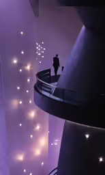 a man is standing on top of a stair way at night
