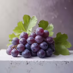 a cluster of red grapes are shown on a ledge