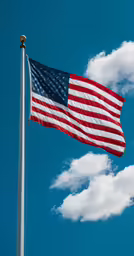 the american flag is flying on a clear day