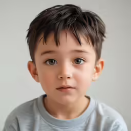 a boy that is looking at the camera