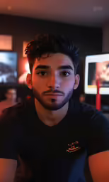 a man sitting down and looking into the camera