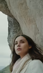 woman posing with rock in the background while leaning against rock