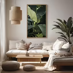 a white living room with two large couches and a plant