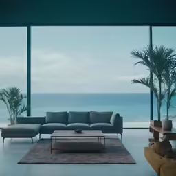 a living room with a couch and large windows